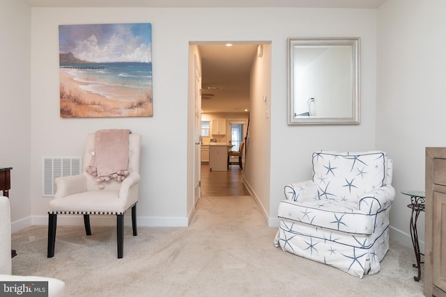 living area with light carpet