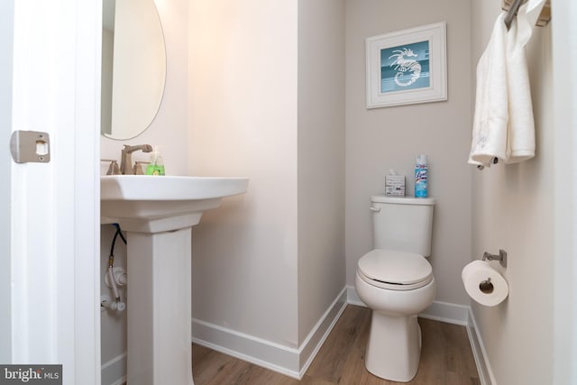 bathroom featuring hardwood / wood-style flooring and toilet