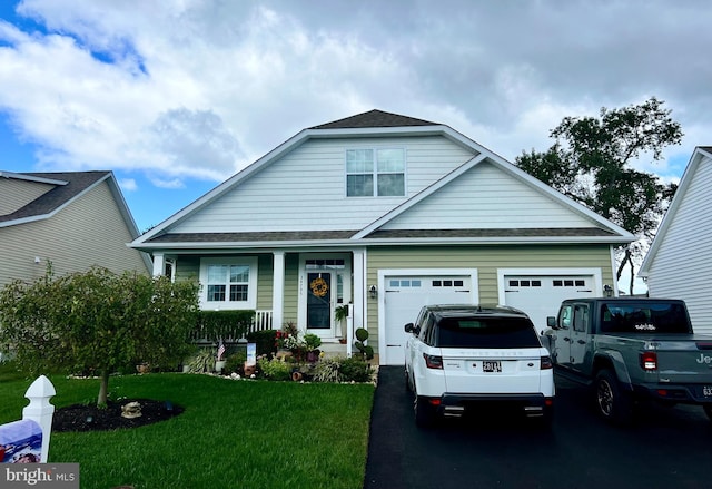 view of front of house with a front yard and a garage