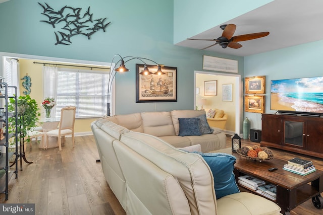 living room featuring light wood-type flooring and ceiling fan