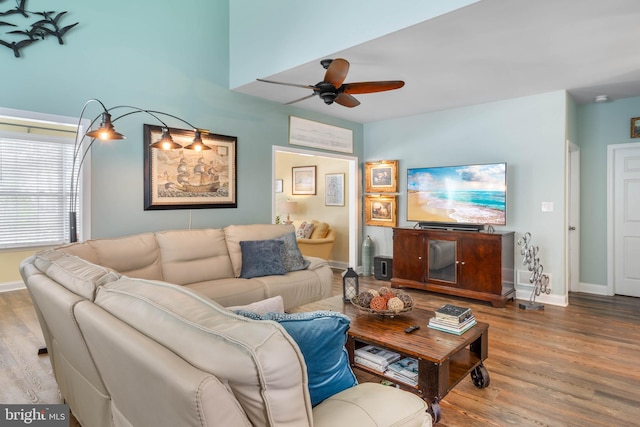 living room with hardwood / wood-style floors and ceiling fan