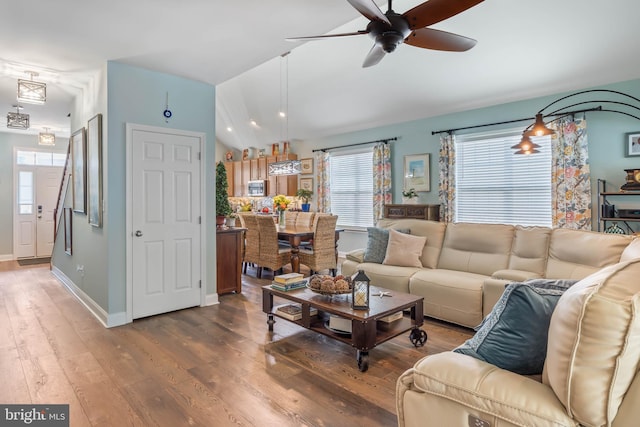 living room with ceiling fan, lofted ceiling, and hardwood / wood-style flooring