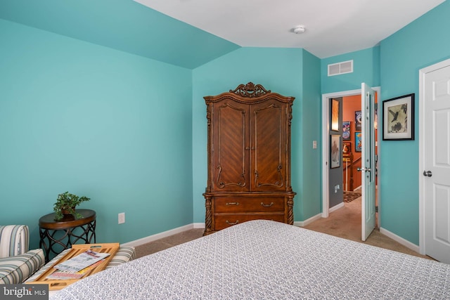 bedroom with light carpet and vaulted ceiling