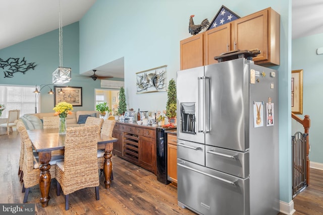 kitchen with high end fridge, dark hardwood / wood-style flooring, and a wealth of natural light