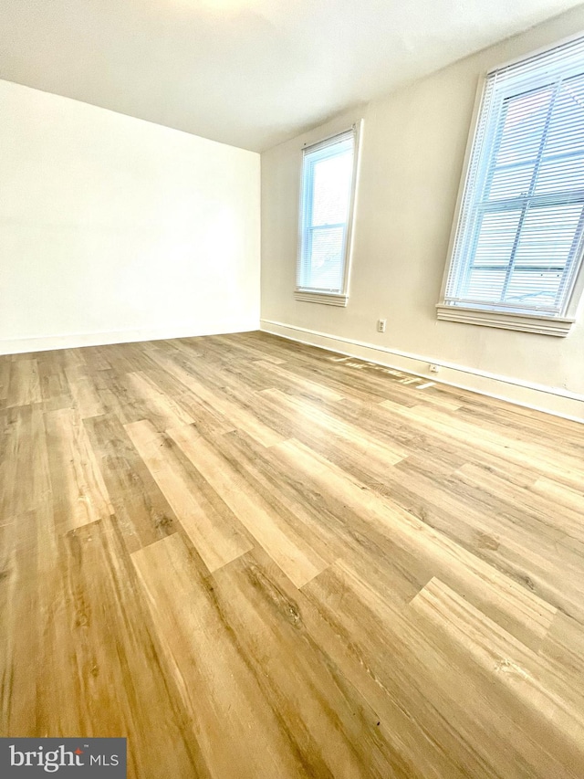 empty room featuring light hardwood / wood-style flooring and plenty of natural light