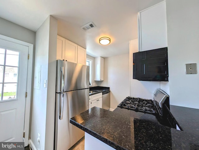 kitchen featuring visible vents, dark stone countertops, white cabinetry, and stainless steel appliances