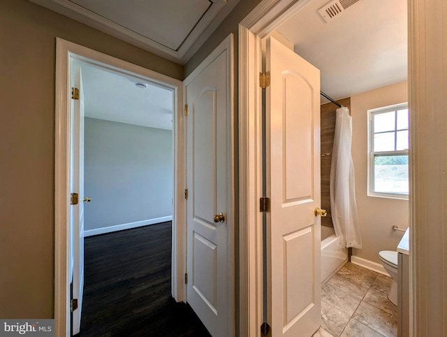 corridor with hardwood / wood-style floors