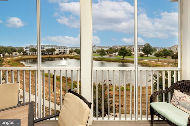 unfurnished sunroom featuring a water view