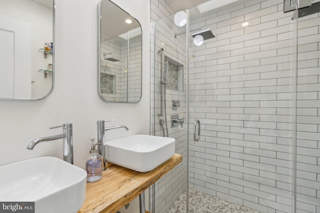 bathroom featuring vanity and a shower with shower door