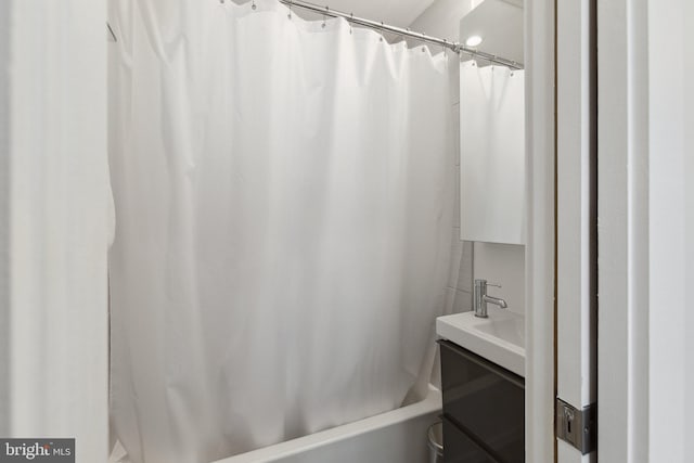 bathroom featuring shower / tub combo and vanity