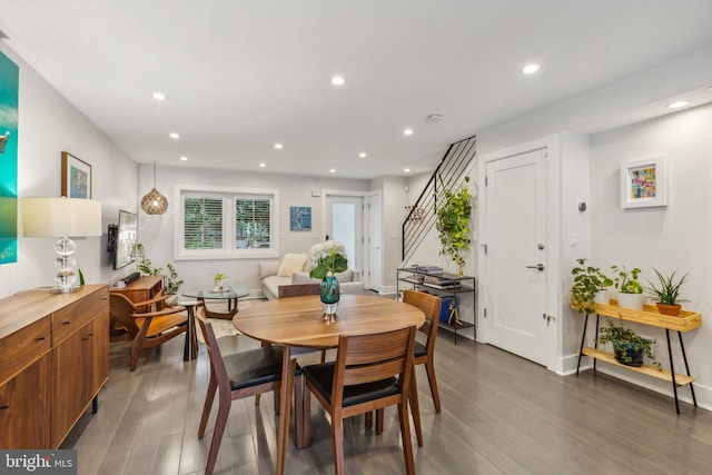 dining area featuring dark wood-type flooring