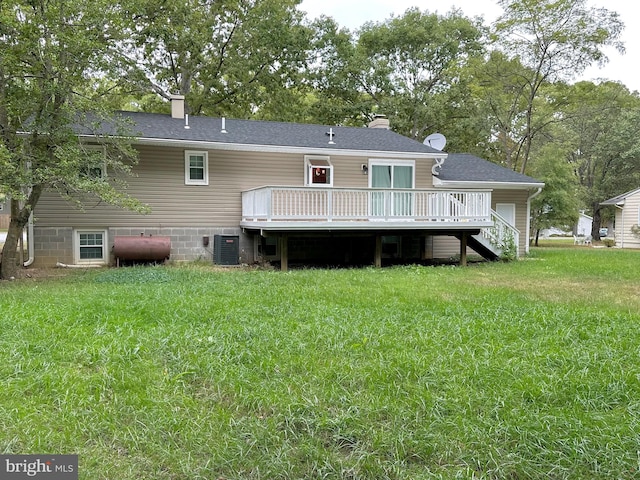 rear view of house with central AC, a yard, and a wooden deck