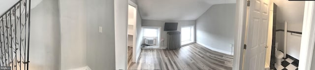 hallway with hardwood / wood-style floors and a wall mounted air conditioner