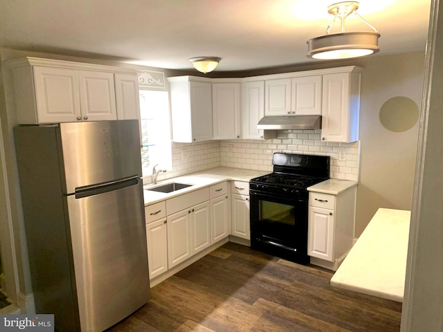 kitchen featuring white cabinets, stainless steel fridge, sink, black gas range, and dark wood-type flooring