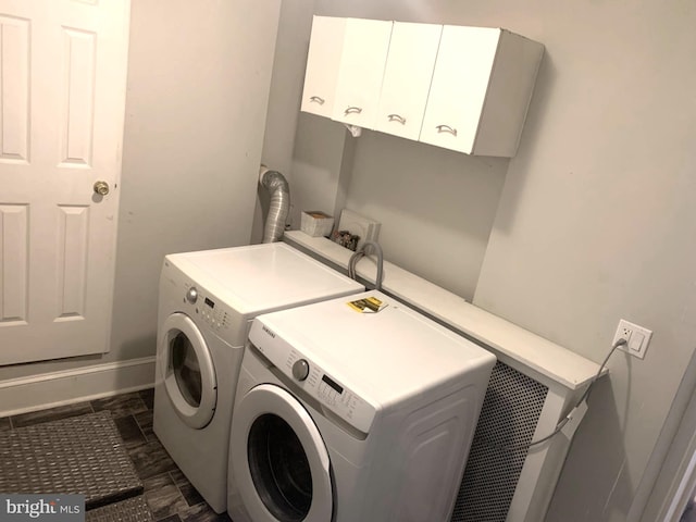 laundry room featuring cabinets and washing machine and dryer