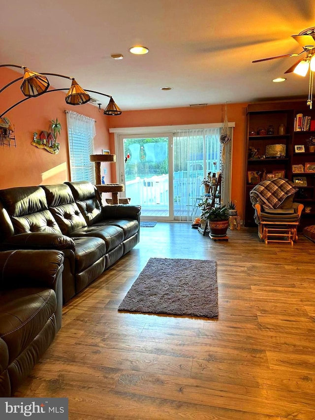 living room with ceiling fan and hardwood / wood-style floors