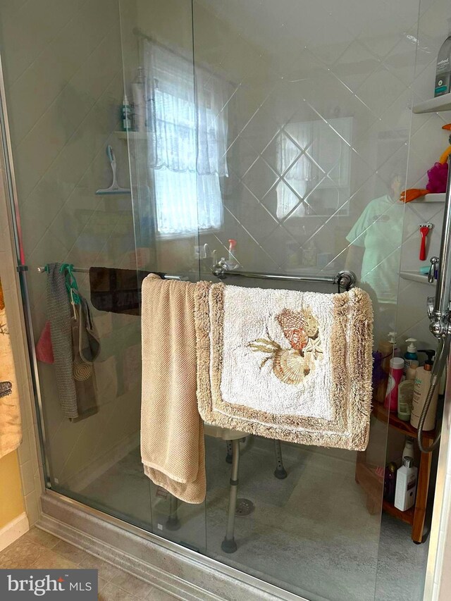 bathroom featuring walk in shower and tile patterned flooring