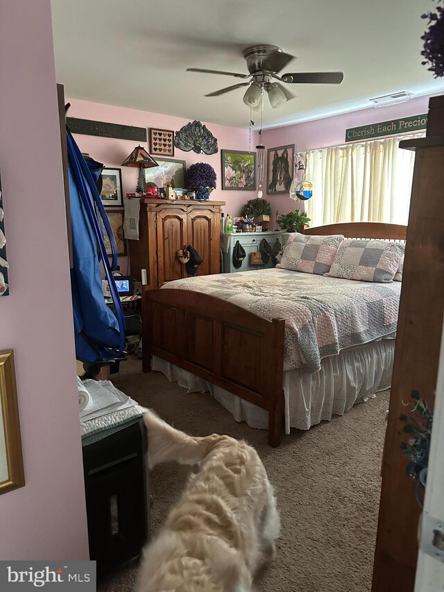 bedroom featuring ceiling fan and carpet