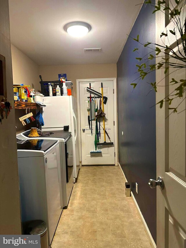 clothes washing area featuring washer and clothes dryer