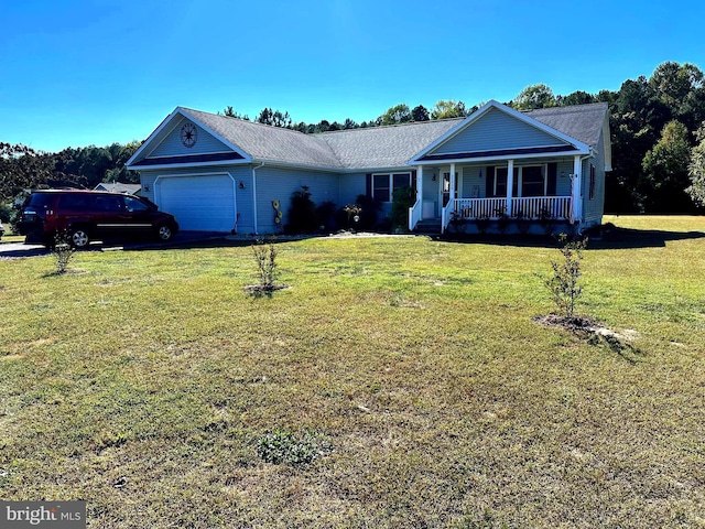 ranch-style house featuring covered porch, a front yard, and a garage