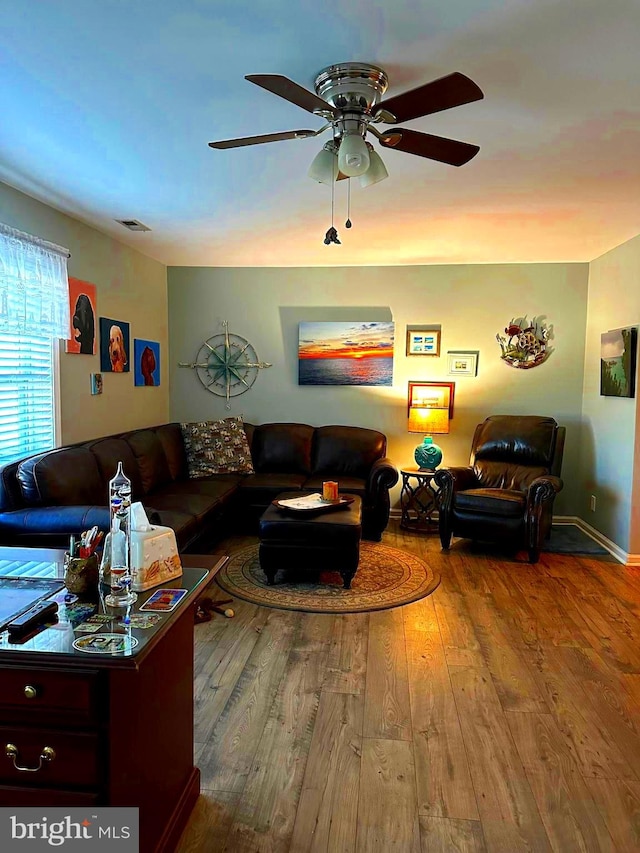 living room featuring hardwood / wood-style flooring and ceiling fan