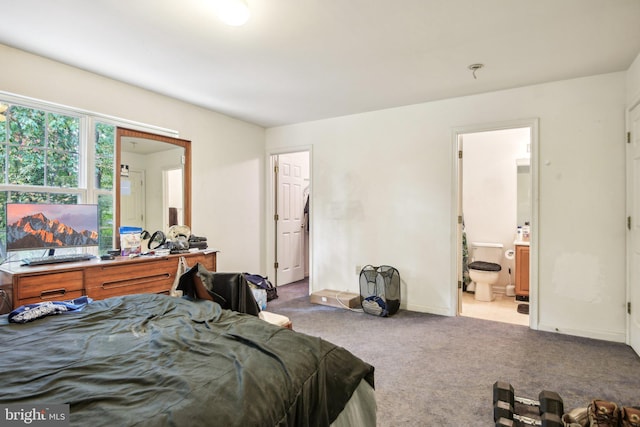 bedroom featuring connected bathroom and light colored carpet