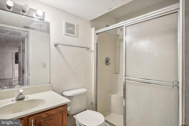 bathroom featuring walk in shower, vanity, and toilet