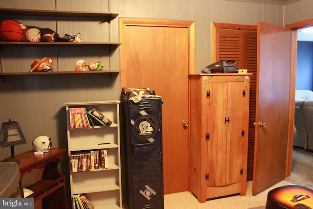 interior space with wooden walls and light carpet