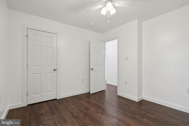 unfurnished bedroom featuring a closet, ceiling fan, and dark wood-type flooring