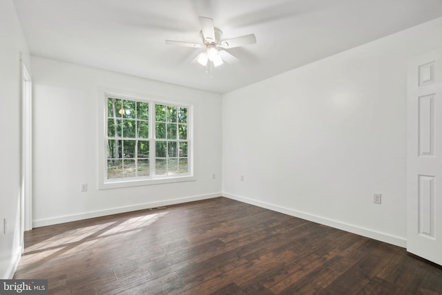 unfurnished room with ceiling fan and dark hardwood / wood-style flooring