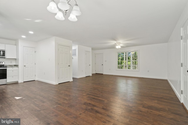 unfurnished living room with ceiling fan with notable chandelier and dark hardwood / wood-style floors