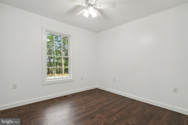 unfurnished room with ceiling fan and dark hardwood / wood-style flooring