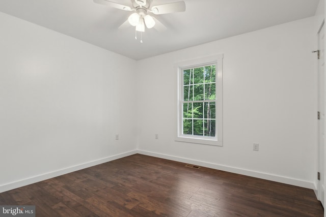 spare room featuring ceiling fan and dark hardwood / wood-style flooring