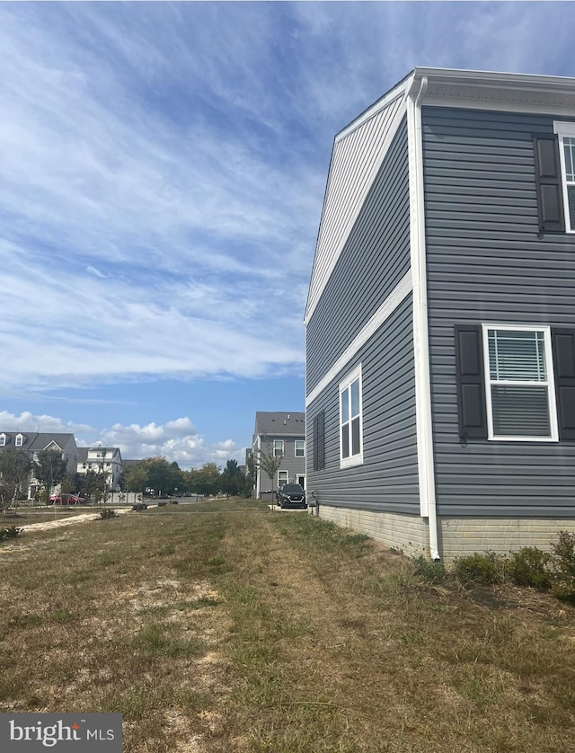 view of property exterior with a lawn