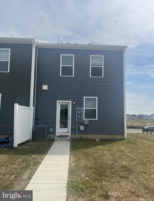 view of front facade with central AC unit and a front yard