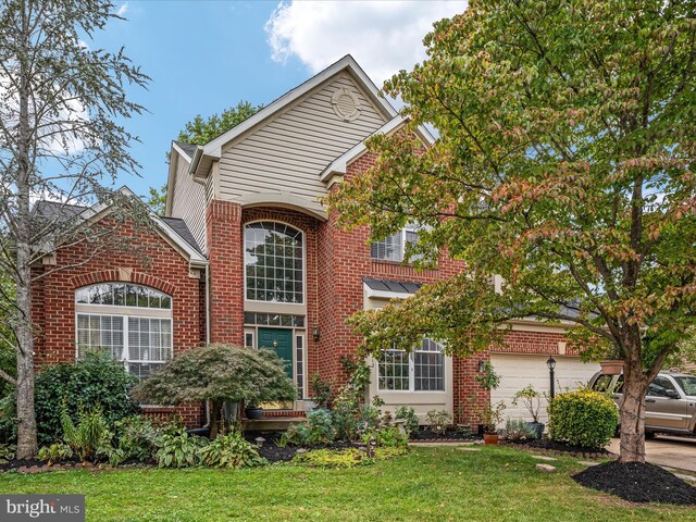 front facade with a front yard and a garage