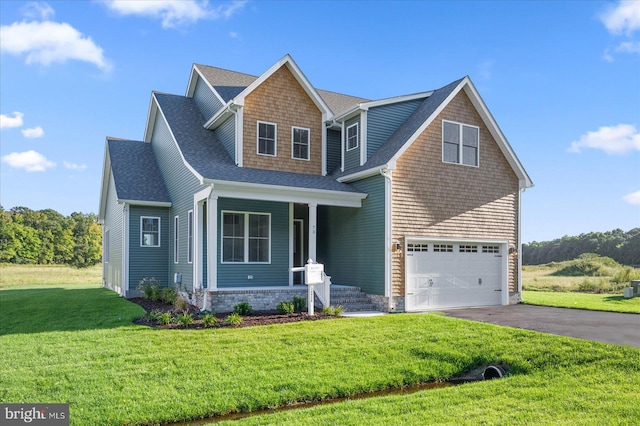 view of front of house featuring a front yard and a garage