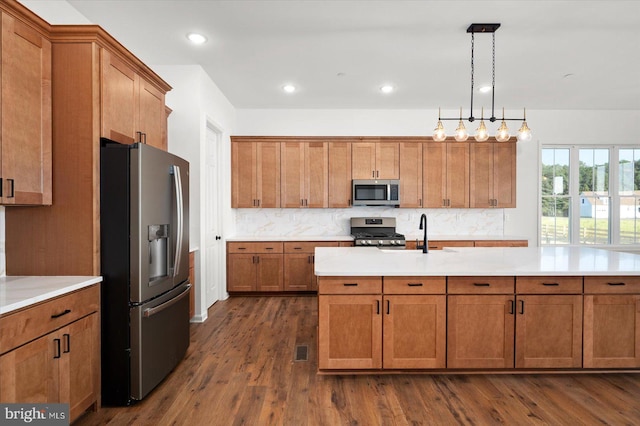 73 King Richard Rd, Berlin, MD 21811 - kitchen with decorative backsplash, light countertops, appliances with stainless steel finishes, a sink, and brown cabinetry