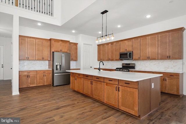 73 King Richard Rd, Berlin, MD 21811 - kitchen featuring stainless steel appliances, dark wood-type flooring, an island with sink, and brown cabinets