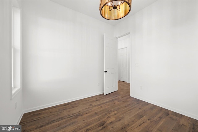 73 King Richard Rd, Berlin, MD 21811 - empty room featuring baseboards, dark wood-style flooring, and a chandelier