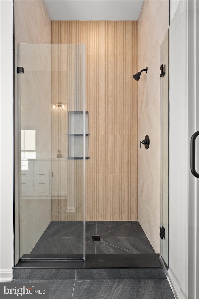 bathroom with a shower with door