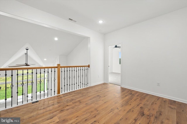 unfurnished room with lofted ceiling, ceiling fan, and wood-type flooring