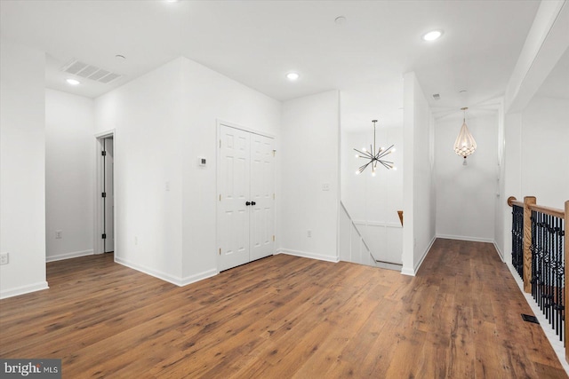 interior space featuring hardwood / wood-style flooring and a notable chandelier