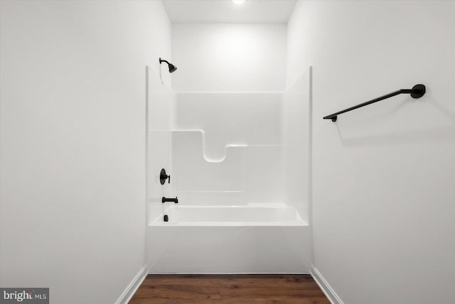 bathroom with hardwood / wood-style floors and shower / bathing tub combination