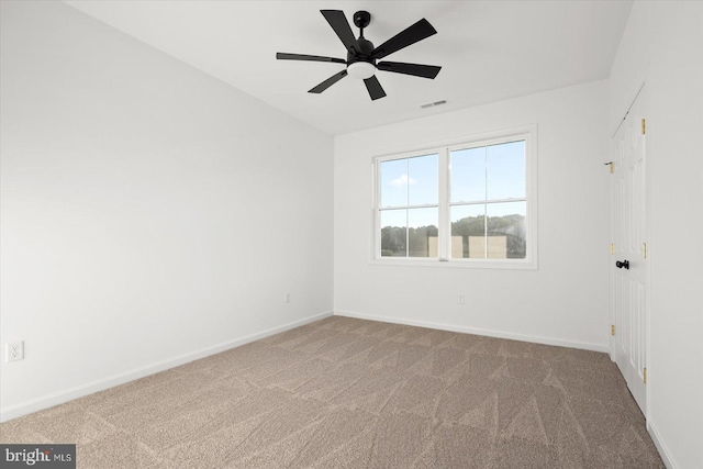 carpeted empty room featuring ceiling fan