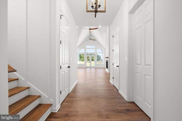 corridor featuring dark hardwood / wood-style floors and lofted ceiling