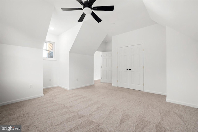 bonus room with light carpet, ceiling fan, and lofted ceiling