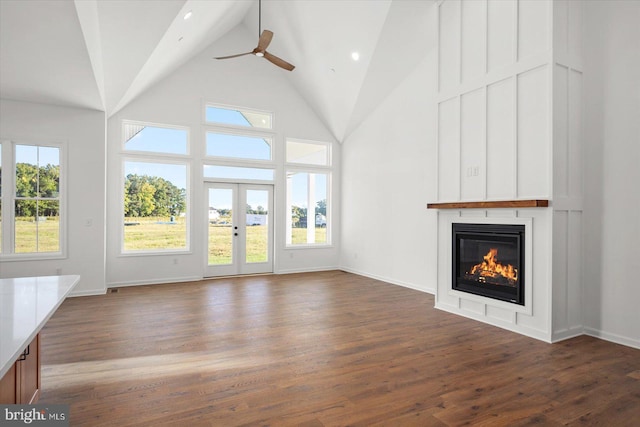 73 King Richard Rd, Berlin, MD 21811 - unfurnished living room with high vaulted ceiling, a large fireplace, baseboards, a ceiling fan, and dark wood-style floors