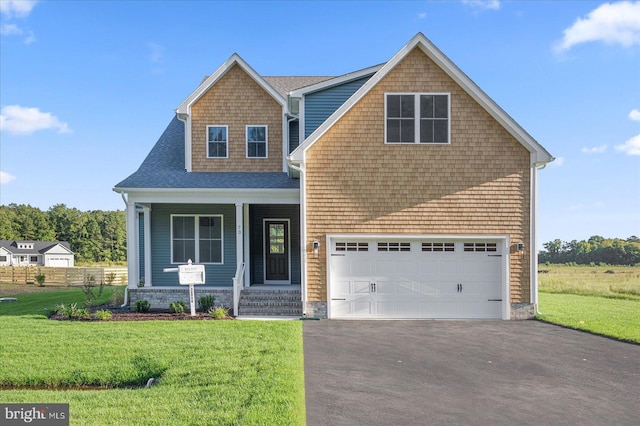 view of front facade featuring a front yard and a garage