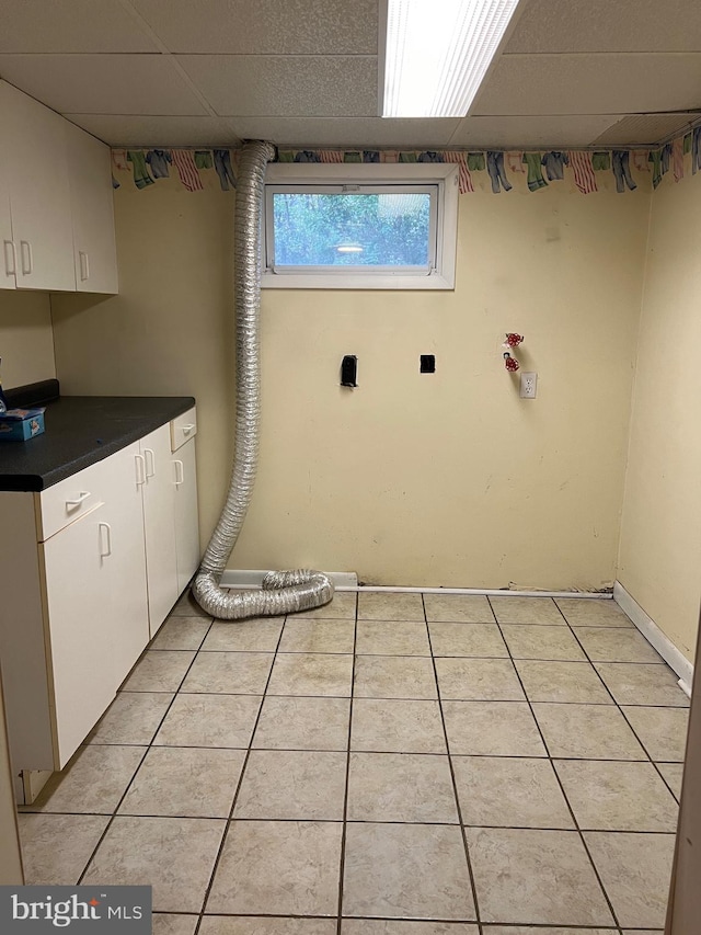 washroom featuring light tile patterned floors and cabinets